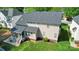 Aerial view of the home showcasing the backyard, screened porch, and well-manicured lawn at 9715 Aragorn Nw Ln, Charlotte, NC 28269