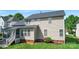 Back of home with a screened porch, a well-maintained lawn, and attractive landscaping at 9715 Aragorn Nw Ln, Charlotte, NC 28269