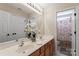 Bathroom featuring double sinks, modern lighting, and a shower with decorative curtain at 9715 Aragorn Nw Ln, Charlotte, NC 28269