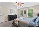 Bedroom with a comfortable bed, natural light, and dark wood dresser at 9715 Aragorn Nw Ln, Charlotte, NC 28269