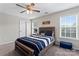 Comfortable bedroom featuring a bed with natural lighting and a ceiling fan at 9715 Aragorn Nw Ln, Charlotte, NC 28269
