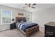 Bedroom featuring a ceiling fan, natural light, and a comfortable bed at 9715 Aragorn Nw Ln, Charlotte, NC 28269