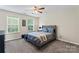 Comfortable bedroom featuring a ceiling fan and two windows for natural light at 9715 Aragorn Nw Ln, Charlotte, NC 28269