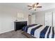 Comfortable bedroom with neutral walls, ceiling fan, dresser, and an inspirational sign hanging on the wall at 9715 Aragorn Nw Ln, Charlotte, NC 28269