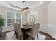 Traditional dining room with wood table, upholstered chairs, and stylish lighting fixture at 9715 Aragorn Nw Ln, Charlotte, NC 28269