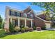 Beautiful brick home with a cozy front porch, manicured landscaping, and an attached two-car garage on a sunny day at 9715 Aragorn Nw Ln, Charlotte, NC 28269