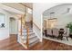 Elegant foyer with hardwood floors, a staircase, and an archway leading to the dining room at 9715 Aragorn Nw Ln, Charlotte, NC 28269