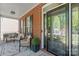 Covered front porch with cozy seating area, black shutters, and a decorative front door enhances curb appeal at 9715 Aragorn Nw Ln, Charlotte, NC 28269