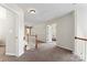 Well-lit hallway with carpeted floors, white walls, and open doorways leading to other rooms at 9715 Aragorn Nw Ln, Charlotte, NC 28269
