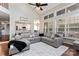 Bright living room featuring vaulted ceilings, an oversized sectional sofa, and breakfast bar to kitchen at 9715 Aragorn Nw Ln, Charlotte, NC 28269