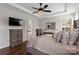 Comfortable main bedroom featuring wood floors, stylish furnishings, and access to the bathroom at 9715 Aragorn Nw Ln, Charlotte, NC 28269