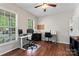 Bright home office with hardwood floors, multiple workstations, and natural light from large windows at 9715 Aragorn Nw Ln, Charlotte, NC 28269