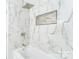 Bathroom with elegant marble tile, showerhead, and built-in niche at 103 Carriage House Dr, Kannapolis, NC 28081
