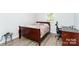 Bedroom with a queen bed and desk, with wood laminate floors at 103 Carriage House Dr, Kannapolis, NC 28081