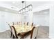 Dining room with a stylish chandelier, and an adjacent hallway to the kitchen at 103 Carriage House Dr, Kannapolis, NC 28081