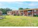 Exterior of a complex of condos, with well maintained grassy areas at 103 Carriage House Dr, Kannapolis, NC 28081