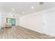 A modern living room with sleek flooring, recessed lighting, and a sliding glass door that brings in natural light at 103 Carriage House Dr, Kannapolis, NC 28081