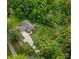Aerial view of the home surrounded by lush greenery, a long driveway and a spacious yard at 10340 Williams Rd, Mint Hill, NC 28227