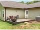Cozy back deck with outdoor seating, fire pit, and a convenient back door at 10340 Williams Rd, Mint Hill, NC 28227