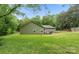Lush backyard featuring the back of the house, deck, and a wooden fence at 10340 Williams Rd, Mint Hill, NC 28227