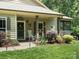 Inviting front porch with rocking chairs and decorative plants creating a cozy and welcoming entrance at 10340 Williams Rd, Mint Hill, NC 28227