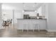 Bright, open kitchen with white cabinetry, a breakfast bar, and seamless flow into the adjacent dining area at 10340 Williams Rd, Mint Hill, NC 28227