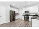 Modern kitchen featuring white cabinets, stainless steel appliances, and stylish granite countertops at 10340 Williams Rd, Mint Hill, NC 28227