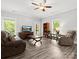 Comfortable living room with neutral walls, ceiling fan, and large windows offering plenty of natural light at 10340 Williams Rd, Mint Hill, NC 28227