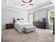 Spacious main bedroom with tray ceiling, neutral colors, and natural light from large windows at 10340 Williams Rd, Mint Hill, NC 28227