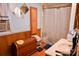Functional bathroom features a vanity, shower, and wood paneling for a rustic appeal at 1042 Jackson Rd, Fort Lawn, SC 29714