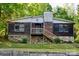 A charming house with a stone foundation and wooden siding, offering a cozy and inviting curb appeal at 1042 Jackson Rd, Fort Lawn, SC 29714