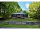 Rustic home with a stone foundation and wooden siding, nestled amongst lush greenery for added privacy at 1042 Jackson Rd, Fort Lawn, SC 29714