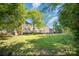 Spacious backyard with mature trees and a well-maintained lawn provides a private outdoor space at 106 Friendfield Dr # B, Fort Mill, SC 29715