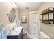 Well-lit bathroom featuring vanity, shower, decorative mirrors and convenient shelving at 106 Friendfield Dr # B, Fort Mill, SC 29715