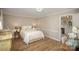 Cozy bedroom with ample lighting, an adjacent office space, and hardwood flooring at 106 Friendfield Dr # B, Fort Mill, SC 29715