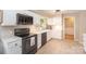 Bright kitchen with black appliances, white cabinets, and a view of the yard through the window at 106 Friendfield Dr # B, Fort Mill, SC 29715