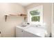 Well-lit laundry room featuring modern washer and dryer units plus convenient shelf space at 106 Friendfield Dr # B, Fort Mill, SC 29715