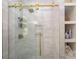 Modern glass shower with gold hardware, built-in shelves, and elegant tile work at 106 Friendfield Dr # B, Fort Mill, SC 29715