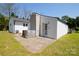 Backyard featuring a brick patio and grassy area adjacent to the home's back door at 1081 Deas St, Rock Hill, SC 29732