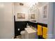 Functional bathroom featuring black and white tile, a vanity, and a well-lit mirror at 1081 Deas St, Rock Hill, SC 29732