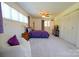 Cozy bedroom featuring a purple comforter, chair, neutral carpet, and ample natural light at 1081 Deas St, Rock Hill, SC 29732