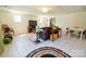 Open living area with a tv and adjacent dining space, tiled flooring, and neutral decor at 1081 Deas St, Rock Hill, SC 29732