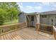 Wooden back deck featuring wood railings and view of home exterior and surrounding yard at 1119 Highway 218 W Hwy, Indian Trail, NC 28079
