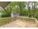 Expansive back yard featuring a wood deck, lush trees, a storage shed, and mature trees at 1119 Highway 218 W Hwy, Indian Trail, NC 28079