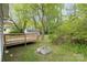 Spacious back yard showcases lush trees, a wood deck, utility access, and varied vegetation at 1119 Highway 218 W Hwy, Indian Trail, NC 28079
