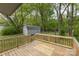 Expansive back yard featuring a wood deck, lush trees, a storage shed, and mature trees at 1119 Highway 218 W Hwy, Indian Trail, NC 28079