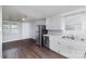 Bright kitchen with white cabinets, stainless steel appliances, and wood-look flooring at 1119 Highway 218 W Hwy, Indian Trail, NC 28079