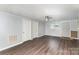 Light and airy living room with wood-look flooring, neutrally painted walls, and updated ceiling fan at 1119 Highway 218 W Hwy, Indian Trail, NC 28079