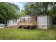 Exterior shot of home featuring a deck and a well-maintained lawn with a brick-lined foundation at 114 Oakland Rd, Belmont, NC 28012