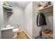Compact bathroom with a toilet, sink, and built-in closet and storage at 114 Oakland Rd, Belmont, NC 28012